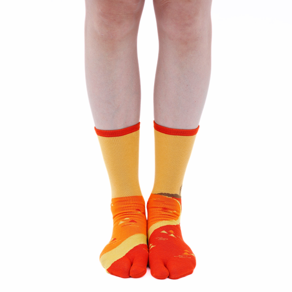 Person wearing long orange Tabi Socks " Enoshim ", front view