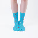 Person wearing long light blue Tabi Socks " Surfer ", front view