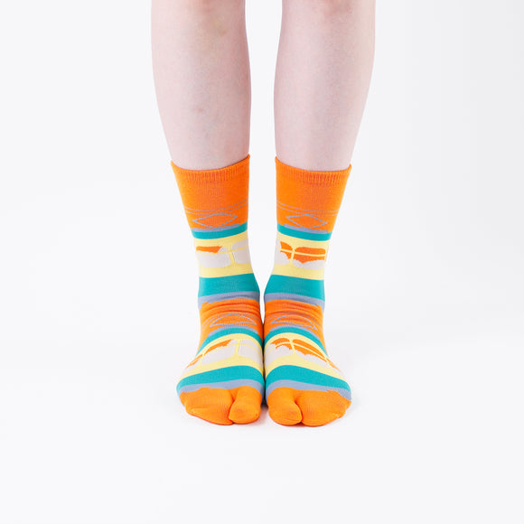 Person wearing long orange Tabi Socks " Densha ", front view