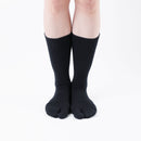 Person wearing black Tabi Socks "NOBI NOBI", front view